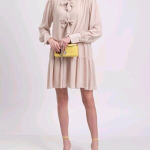 Elegant Cream Dress with Bow Details